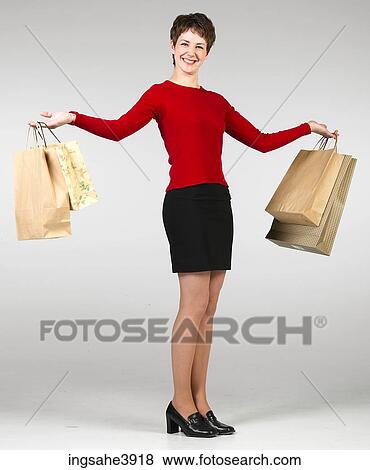 Young woman holding a lot of shopping bags View Large Photo Image Stock Photo - Young woman holding a lot of shopping bags. Fotosearch