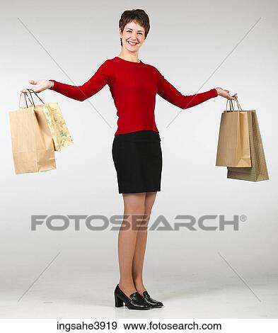 Young woman holding a lot of shopping bags View Large Photo Image Stock Photo - Young woman holding a lot of shopping bags . Fotosearch