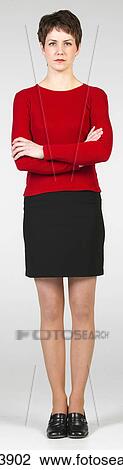 Stock Image - Young woman posing with her arms folded. Fotosearch
