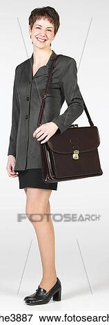 Young woman smiling and carrying a brown office handbag View Large Photo Image Stock Photo - Young woman smiling and carrying a brown office handbag . Fotosearch