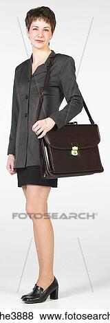 Young woman smiling and carrying a brown office handbag View Large Photo Image Stock Photo - Young woman smiling and carrying a brown office handbag. Fotosearch