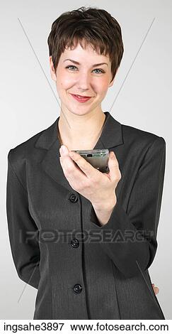 Young woman smiling and holding a personal digital assistant View Large Photo Image Stock Photo - Young woman smiling and holding a personal digital assistant . Fotosearch