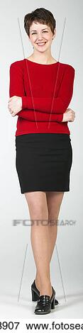 Young woman smiling and posing with her arms folded View Large Photo Image Stock Photo - Young woman smiling and posing with her arms folded . Fotosearch