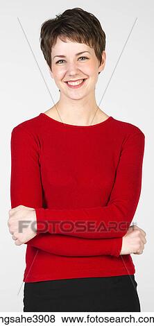 Stock Photo - Young woman smiling and posing with her arms folded. Fotosearch