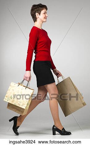 Young woman smiling and walking View Large Photo Image Picture - Young woman smiling and walking. Fotosearch