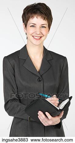 Young woman smiling and writing in a organizer View Large Photo Image Stock Image - Young woman smiling and writing in a organizer. Fotosearch