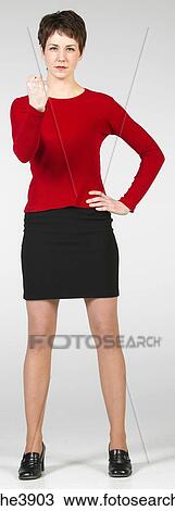 Young woman standing in a threatening stance View Large Photo Image Stock Image - Young woman standing in a threatening stance. Fotosearch