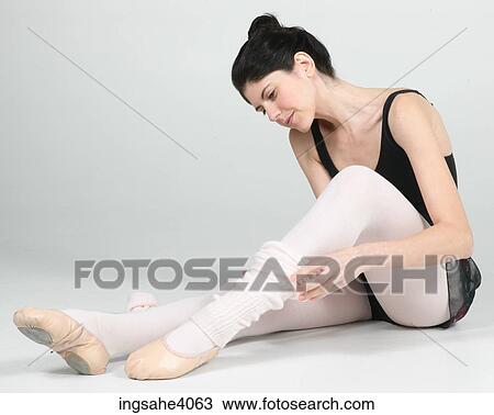 Stock Image - Ballerina seated on the floor . Fotosearch