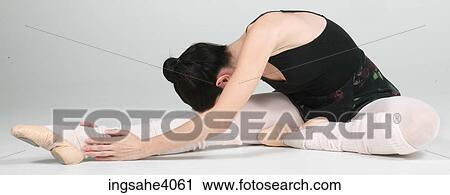 Stock Image - Ballerina stretched on the floor . Fotosearch