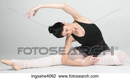 Stock Image - Ballerina stretched on the floor . Fotosearch