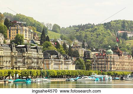 Boats moored along riverbank of European town View Large Photo Image Stock Image - Boats moored along riverbank of European town . Fotosearch