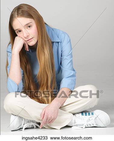 Bored teenaged girl sitting cross-legged View Large Photo Image Stock Image - Bored teenaged girl sitting cross-legged . Fotosearch