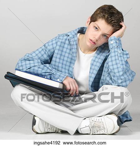 Bored teenager studying from binder View Large Photo Image Stock Image - Bored teenager studying from binder. Fotosearch