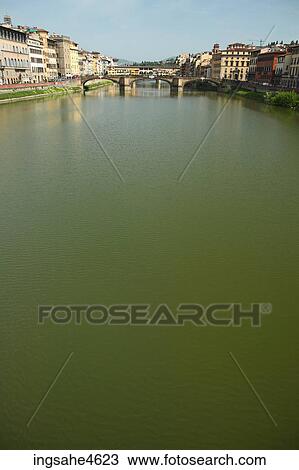Stock Image - Buildings along quiet riverbanks . Fotosearch