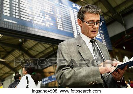 Businessman at train station View Large Photo Image Stock Photo - Businessman at train station . Fotosearch