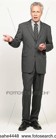 Businessman in black suit making a presentation View Large Photo Image Stock Photo - Businessman in black suit making a presentation. Fotosearch