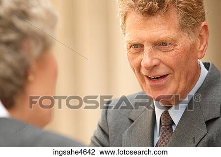 Businessman in conversation View Large Photo Image Stock Image - Businessman in conversation . Fotosearch