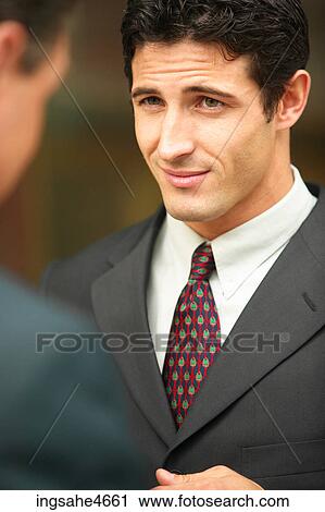 Stock Image - Businessman in conversation . Fotosearch