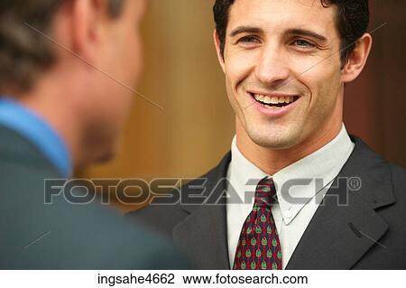 Stock Image - Businessman in conversation . Fotosearch