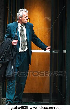 Stock Photograph - Businessman in elevator. Fotosearch