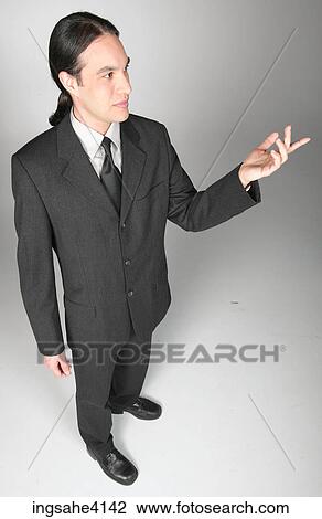 Businessman in gray suit making presentation View Large Photo Image Stock Image - Businessman in gray suit making presentation . Fotosearch