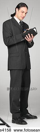Businessman in gray suit writing in organizer View Large Photo Image Stock Photo - Businessman in gray suit writing in organizer . Fotosearch