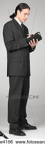Businessman in gray suit writing in organizer View Large Photo Image Stock Photograph - Businessman in gray suit writing in organizer. Fotosearch
