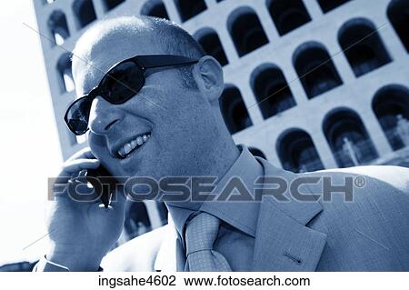 Stock Image - Businessman on cell phone . Fotosearch