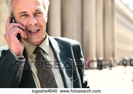 Stock Image - Businessman on cell phone . Fotosearch
