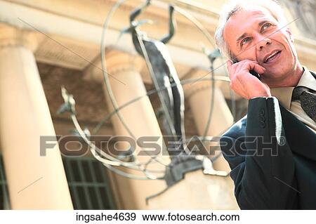Businessman on cell phone View Large Photo Image Stock Photo - Businessman on cell phone . Fotosearch