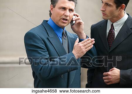 Stock Photo - Businessman on cell phone . Fotosearch