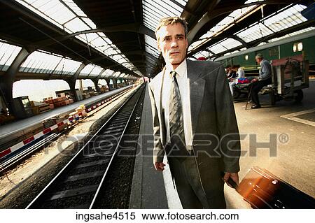 Businessman on train platform View Large Photo Image Stock Photography - Businessman on train platform . Fotosearch