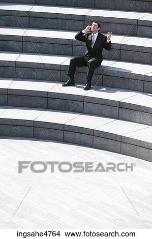 Businessman talking on cell phone View Large Photo Image Picture - Businessman talking on cell phone . Fotosearch