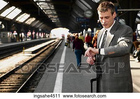 Stock Image - Businessman waiting for train . Fotosearch
