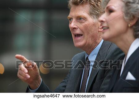 Businesspeople in conversation View Large Photo Image Stock Photo - Businesspeople in conversation . Fotosearch