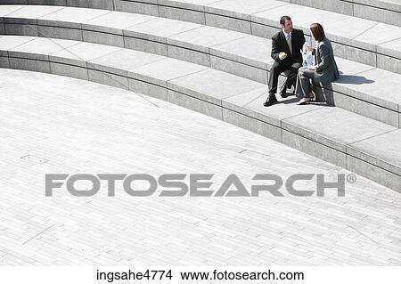 Businesspeople sitting on stairs View Large Photo Image Picture - Businesspeople sitting on stairs . Fotosearch