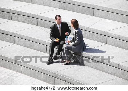 Businesspeople sitting on stairs View Large Photo Image Stock Image - Businesspeople sitting on stairs . Fotosearch