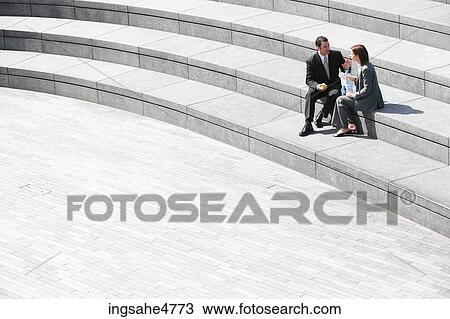 Businesspeople sitting on stairs View Large Photo Image Stock Image - Businesspeople sitting on stairs . Fotosearch