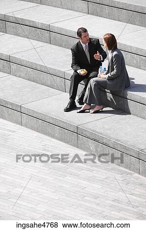 Businesspeople sitting on stairs View Large Photo Image Stock Photo - Businesspeople sitting on stairs . Fotosearch