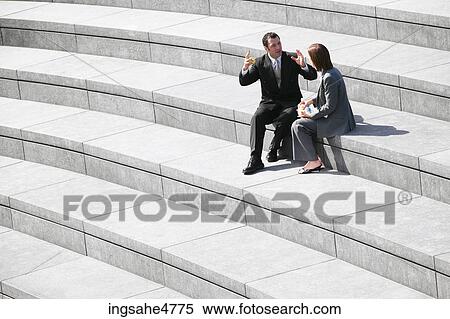Businesspeople sitting on stairs View Large Photo Image Stock Photography - Businesspeople sitting on stairs . Fotosearch