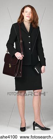 Businesswoman in black suit holding briefcase View Large Photo Image Stock Image - Businesswoman in black suit holding briefcase . Fotosearch