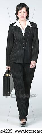 Businesswoman in black suit walking with briefcase View Large Photo Image Stock Photo - Businesswoman in black suit walking with briefcase. Fotosearch
