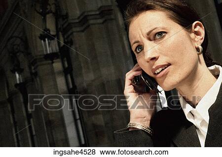Stock Photo - Businesswoman on cell phone . Fotosearch