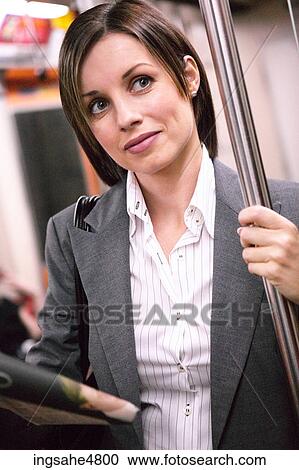 Stock Image - Businesswoman on subway . Fotosearch