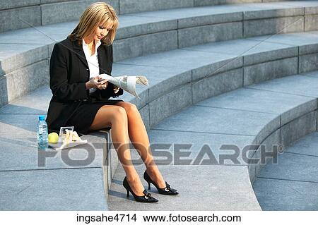 Businesswoman reading newspaper View Large Photo Image Picture - Businesswoman reading newspaper . Fotosearch