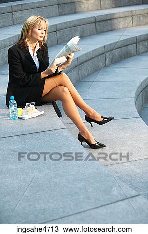 Businesswoman reading newspaper View Large Photo Image Stock Image - Businesswoman reading newspaper . Fotosearch