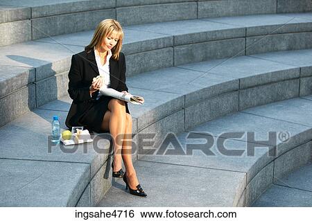 Businesswoman reading newspaper View Large Photo Image Stock Photograph - Businesswoman reading newspaper . Fotosearch