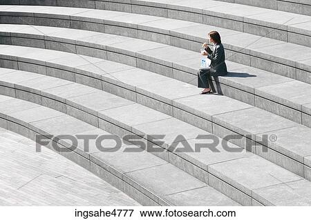 Businesswoman sitting outdoors View Large Photo Image Stock Photo - Businesswoman sitting outdoors . Fotosearch