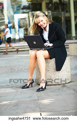 Stock Image - Businesswoman using laptop computer . Fotosearch