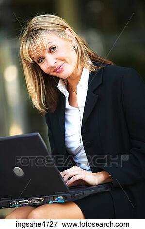 Stock Photo - Businesswoman using laptop computer . Fotosearch
